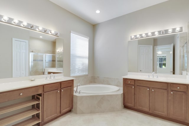 10479 SW Visconti Way, Port Saint Lucie, FL 34986 - bathroom with a stall shower, two vanities, a garden tub, and tile patterned floors