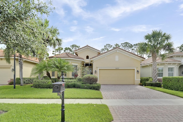 10479 SW Visconti Way, Port Saint Lucie, FL 34986 - mediterranean / spanish-style home featuring stucco siding, decorative driveway, a garage, a front lawn, and a tile roof
