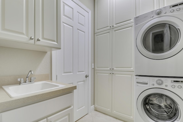 10479 SW Visconti Way, Port Saint Lucie, FL 34986 - laundry room with stacked washer / dryer, cabinet space, and light tile patterned floors