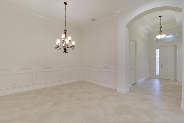 10479 SW Visconti Way, Port Saint Lucie, FL 34986 - spare room with arched walkways, crown molding, light tile patterned flooring, a decorative wall, and a chandelier