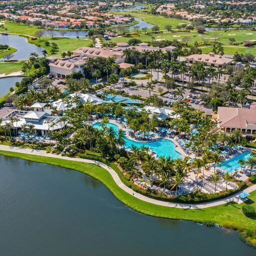 3346 NW 53rd Cir, Boca Raton, FL 33496 - aerial perspective of suburban area with a pool and a nearby body of water