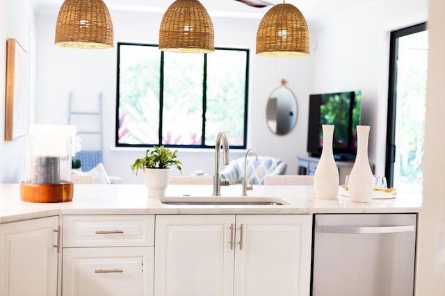 425 NW 12th St, Delray Beach, FL 33444 - kitchen featuring stainless steel dishwasher, white cabinetry, light countertops, and pendant lighting
