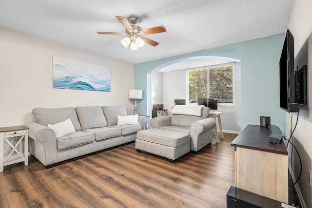 800 Scotia Dr Unit 102, Hypoluxo, FL 33462 - living room with a ceiling fan, dark wood-type flooring, arched walkways, and a textured ceiling