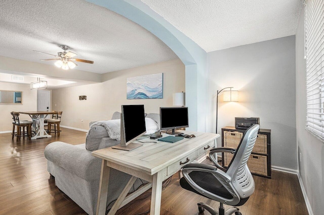 800 Scotia Dr Unit 102, Hypoluxo, FL 33462 - home office featuring a ceiling fan, a textured ceiling, arched walkways, and dark wood-style floors