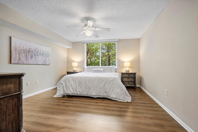 800 Scotia Dr Unit 102, Hypoluxo, FL 33462 - bedroom featuring wood finished floors, a textured ceiling, and a ceiling fan