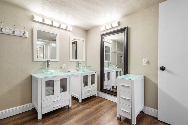 800 Scotia Dr Unit 102, Hypoluxo, FL 33462 - bathroom featuring wood finished floors and two vanities