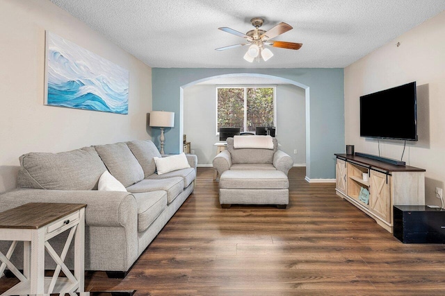 800 Scotia Dr Unit 102, Hypoluxo, FL 33462 - living area featuring arched walkways, ceiling fan, dark wood-style floors, and a textured ceiling