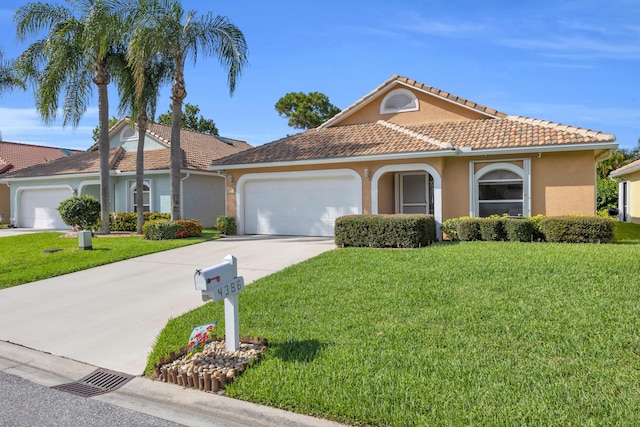 4386 SE Scotland Cay Way, Stuart, FL 34997 - view of front facade featuring stucco siding, an attached garage, a front yard, driveway, and a tile roof