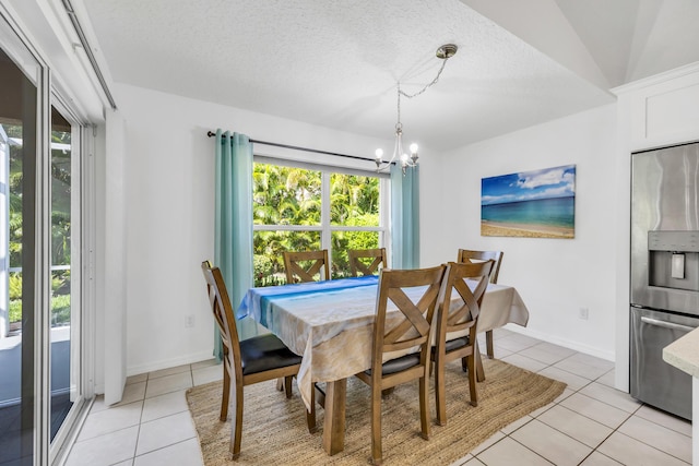 4386 SE Scotland Cay Way, Stuart, FL 34997 - dining room with light tile patterned floors, plenty of natural light, a chandelier, baseboards, and a textured ceiling