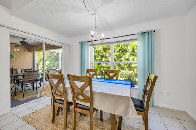 4386 SE Scotland Cay Way, Stuart, FL 34997 - dining space featuring a chandelier, light tile patterned floors, a textured ceiling, and baseboards