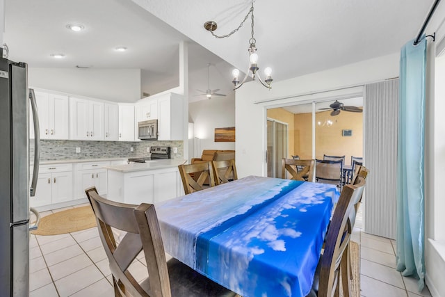 4386 SE Scotland Cay Way, Stuart, FL 34997 - dining area with a ceiling fan, light tile patterned floors, and vaulted ceiling