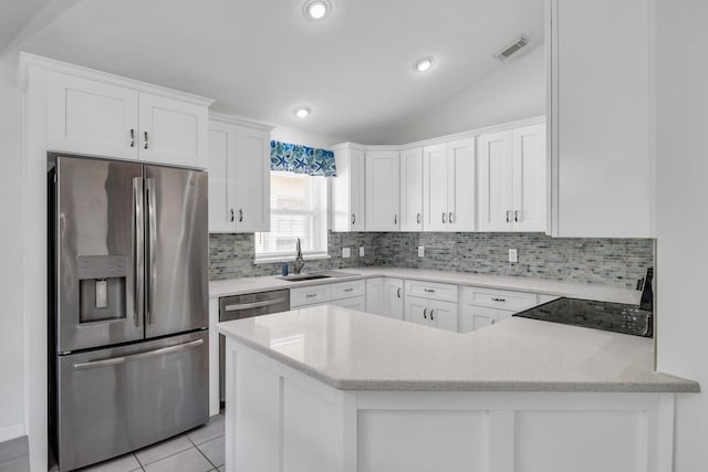 4386 SE Scotland Cay Way, Stuart, FL 34997 - kitchen with stainless steel appliances, a sink, decorative backsplash, white cabinetry, and light stone countertops