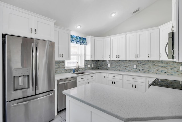 4386 SE Scotland Cay Way, Stuart, FL 34997 - kitchen with appliances with stainless steel finishes, a sink, backsplash, white cabinets, and light stone countertops