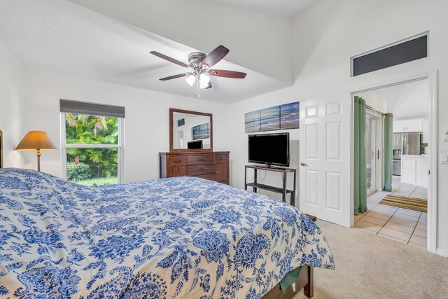 4386 SE Scotland Cay Way, Stuart, FL 34997 - carpeted bedroom with stainless steel fridge, tile patterned floors, and a ceiling fan