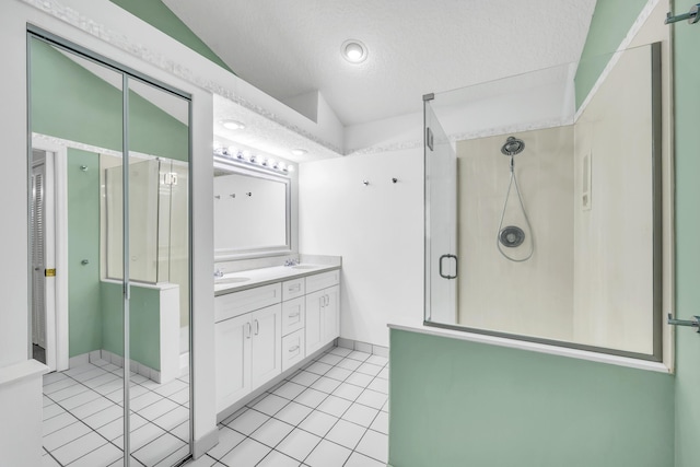 4386 SE Scotland Cay Way, Stuart, FL 34997 - full bathroom with double vanity, a stall shower, tile patterned floors, a textured ceiling, and baseboards