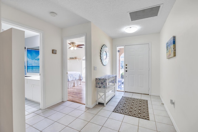 4386 SE Scotland Cay Way, Stuart, FL 34997 - entryway featuring light tile patterned floors, baseboards, a textured ceiling, and a ceiling fan