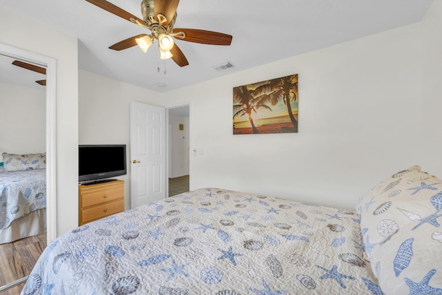 4386 SE Scotland Cay Way, Stuart, FL 34997 - bedroom featuring wood finished floors and a ceiling fan