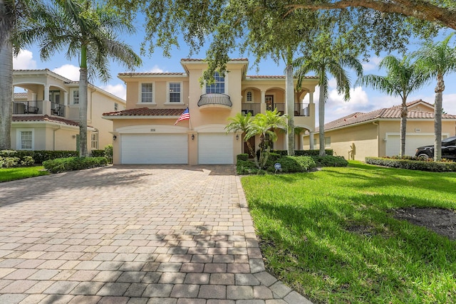 5718 SW Bald Eagle Dr, Palm City, FL 34990 - mediterranean / spanish-style home featuring an attached garage, decorative driveway, stucco siding, a front yard, and a tile roof