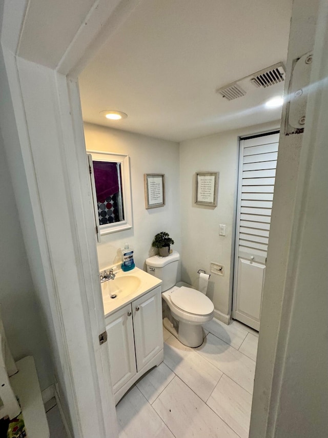 1684 Forest Lakes Cir Unit A, West Palm Beach, FL 33406 - half bath featuring vanity, toilet, and recessed lighting