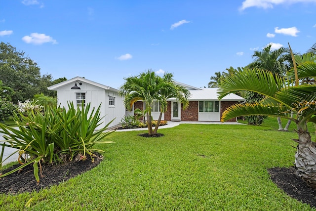 1567 NE Sottong Ave, Jensen Beach, FL 34957 - view of front of home with a front lawn