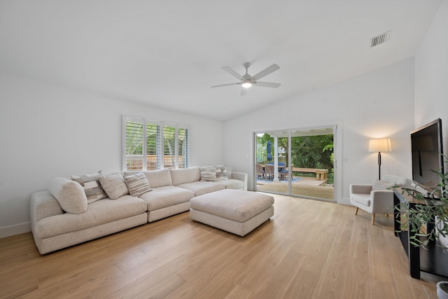1567 NE Sottong Ave, Jensen Beach, FL 34957 - living area with ceiling fan, lofted ceiling, light wood-style floors, and baseboards