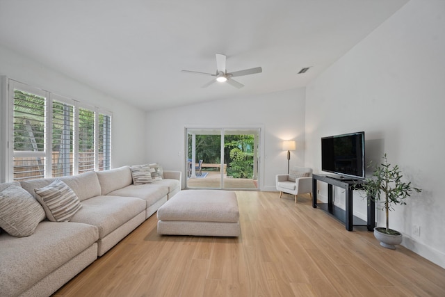1567 NE Sottong Ave, Jensen Beach, FL 34957 - living area featuring lofted ceiling, light wood-type flooring, ceiling fan, healthy amount of natural light, and baseboards