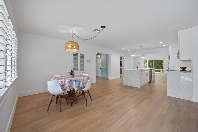 1567 NE Sottong Ave, Jensen Beach, FL 34957 - dining space featuring light wood-style floors, recessed lighting, and baseboards