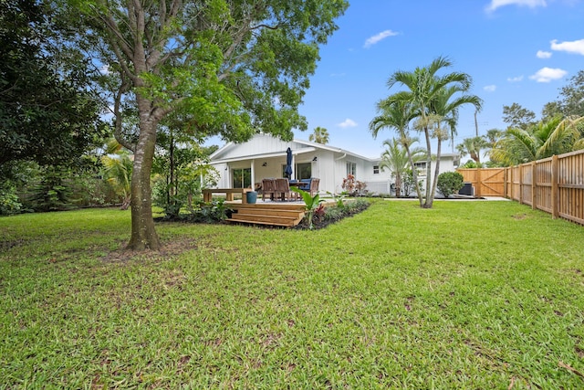 1567 NE Sottong Ave, Jensen Beach, FL 34957 - view of yard featuring a wooden deck