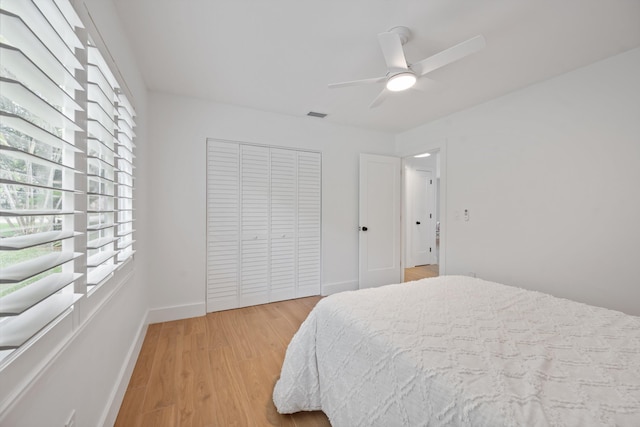 1567 NE Sottong Ave, Jensen Beach, FL 34957 - bedroom with multiple windows, light wood finished floors, a closet, and baseboards