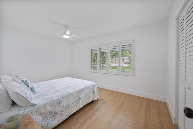 1567 NE Sottong Ave, Jensen Beach, FL 34957 - bedroom with baseboards, wood finished floors, and a ceiling fan