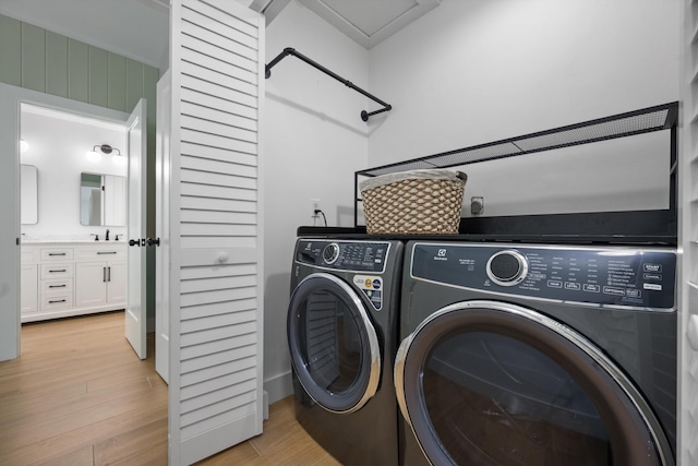 1567 NE Sottong Ave, Jensen Beach, FL 34957 - laundry area featuring light wood finished floors and independent washer and dryer