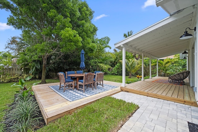 1567 NE Sottong Ave, Jensen Beach, FL 34957 - view of yard featuring a deck, outdoor dining space, and a patio