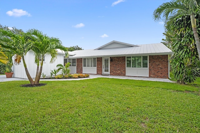 1567 NE Sottong Ave, Jensen Beach, FL 34957 - single story home featuring a front lawn and brick siding