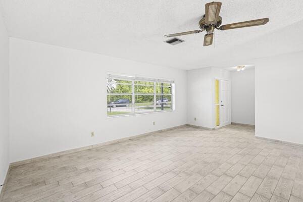 1830 Well Rd, Fort Pierce, FL 34945 - unfurnished room with light wood-type flooring, a ceiling fan, and baseboards