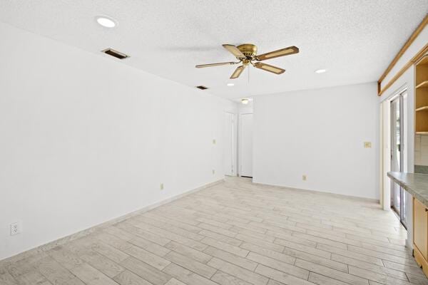 1830 Well Rd, Fort Pierce, FL 34945 - spare room featuring a ceiling fan, light wood finished floors, recessed lighting, and a textured ceiling