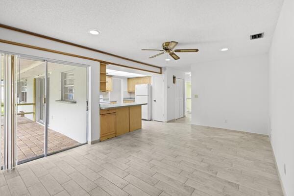 1830 Well Rd, Fort Pierce, FL 34945 - unfurnished living room with ceiling fan, recessed lighting, and light wood-style flooring