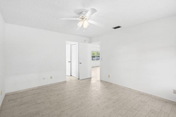 1830 Well Rd, Fort Pierce, FL 34945 - spare room featuring ceiling fan, light wood-style floors, and baseboards