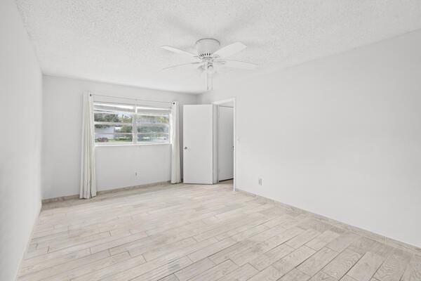 1830 Well Rd, Fort Pierce, FL 34945 - unfurnished room with a ceiling fan, wood finished floors, and a textured ceiling