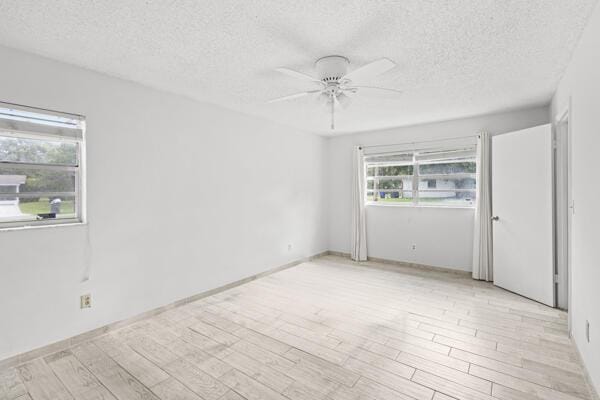 1830 Well Rd, Fort Pierce, FL 34945 - unfurnished room featuring ceiling fan, a textured ceiling, and light wood-style floors