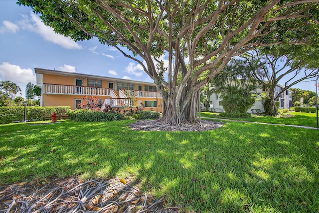 27 Andover Unit B, West Palm Beach, FL 33417 - view of front of home featuring a front yard and stucco siding