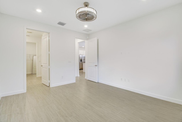 14556 Wiley Range Rd, Delray Beach, FL 33446 - unfurnished bedroom with recessed lighting, light wood-style flooring, and stainless steel refrigerator with ice dispenser