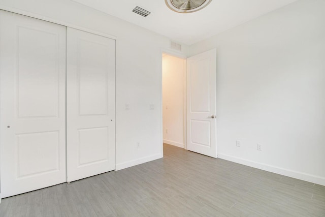 14556 Wiley Range Rd, Delray Beach, FL 33446 - unfurnished bedroom with light wood-style floors and a closet