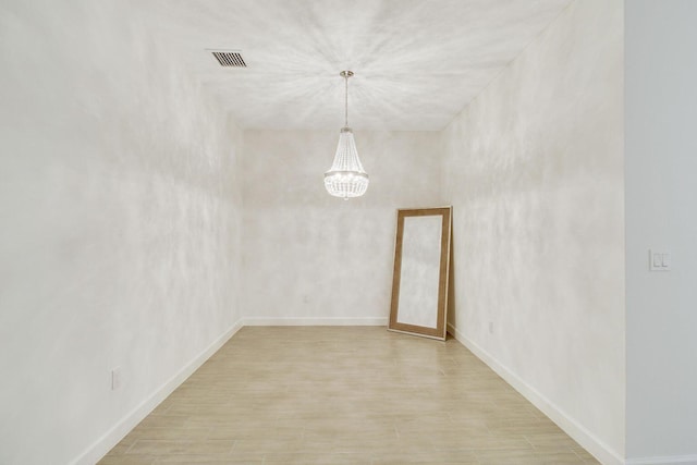14556 Wiley Range Rd, Delray Beach, FL 33446 - spare room with a chandelier and light wood finished floors