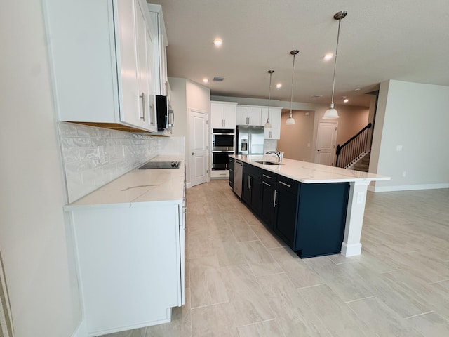 163 SW Pomeroy St, Stuart, FL 34997 - kitchen featuring a sink, appliances with stainless steel finishes, tasteful backsplash, recessed lighting, and a kitchen island with sink