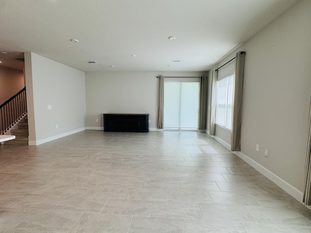 163 SW Pomeroy St, Stuart, FL 34997 - unfurnished living room with stairway, baseboards, and recessed lighting