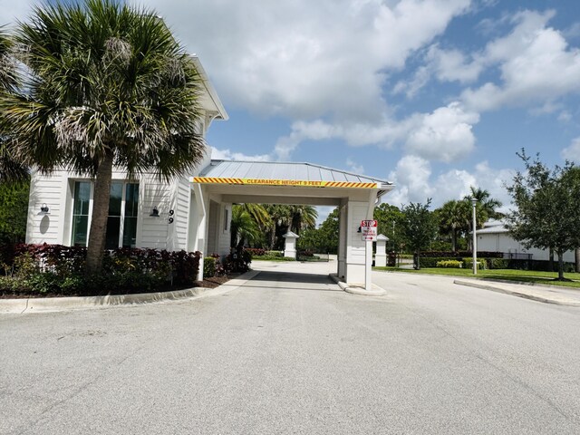 163 SW Pomeroy St, Stuart, FL 34997 - view of asphalt street featuring curbs and street lights