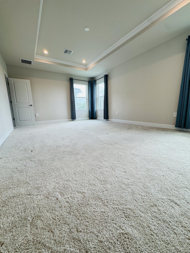 163 SW Pomeroy St, Stuart, FL 34997 - carpeted empty room with a tray ceiling, recessed lighting, baseboards, and crown molding