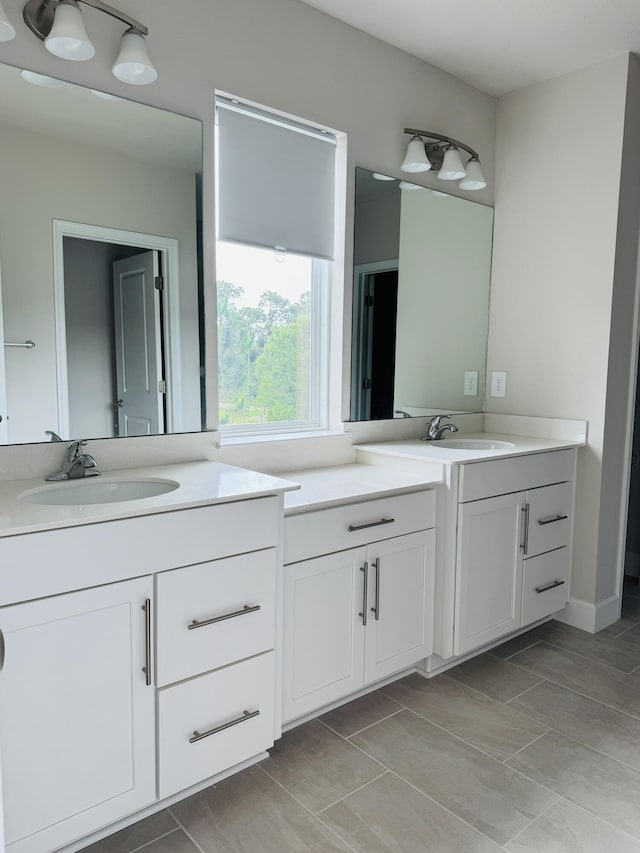 163 SW Pomeroy St, Stuart, FL 34997 - bathroom featuring two vanities and tile patterned floors