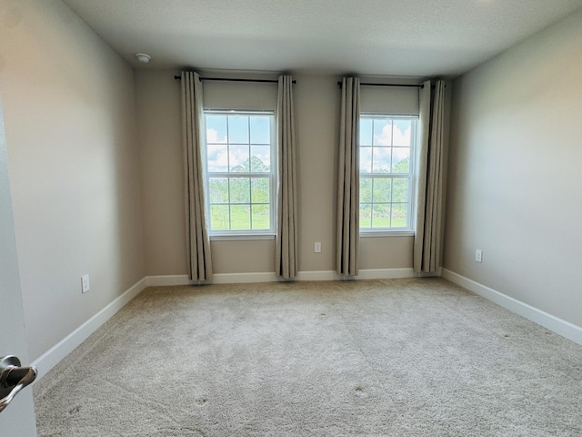 163 SW Pomeroy St, Stuart, FL 34997 - carpeted spare room featuring baseboards and a textured ceiling