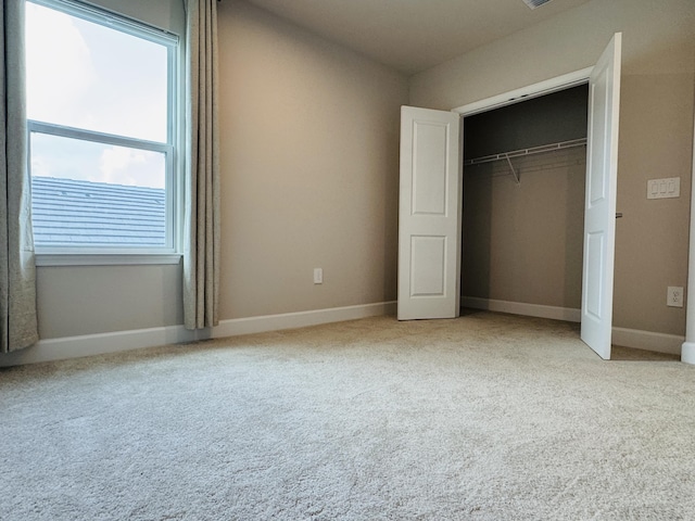 163 SW Pomeroy St, Stuart, FL 34997 - unfurnished bedroom with a closet, carpet flooring, and baseboards